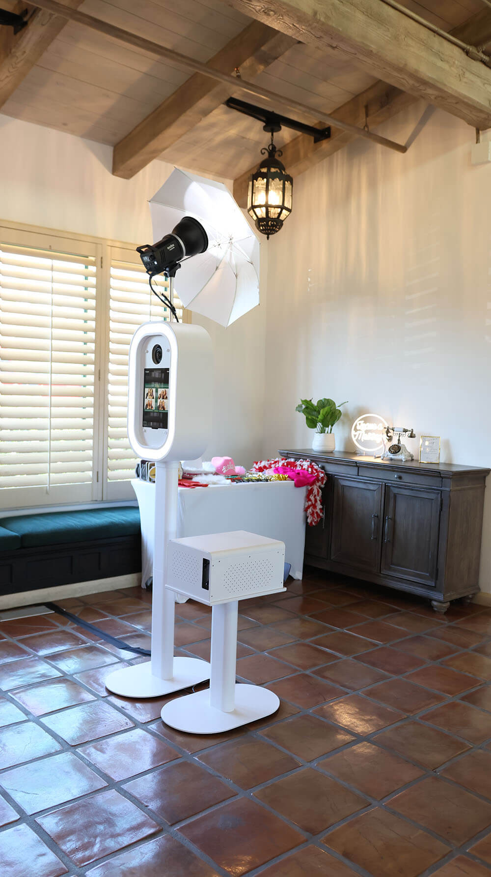 white photo booth with printing station
